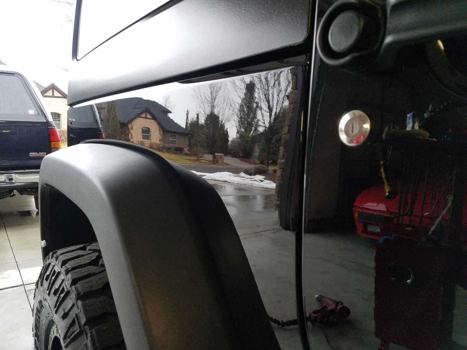 Door ding in quarter panel of Jeep Wrangler repaired with paintless dent repair