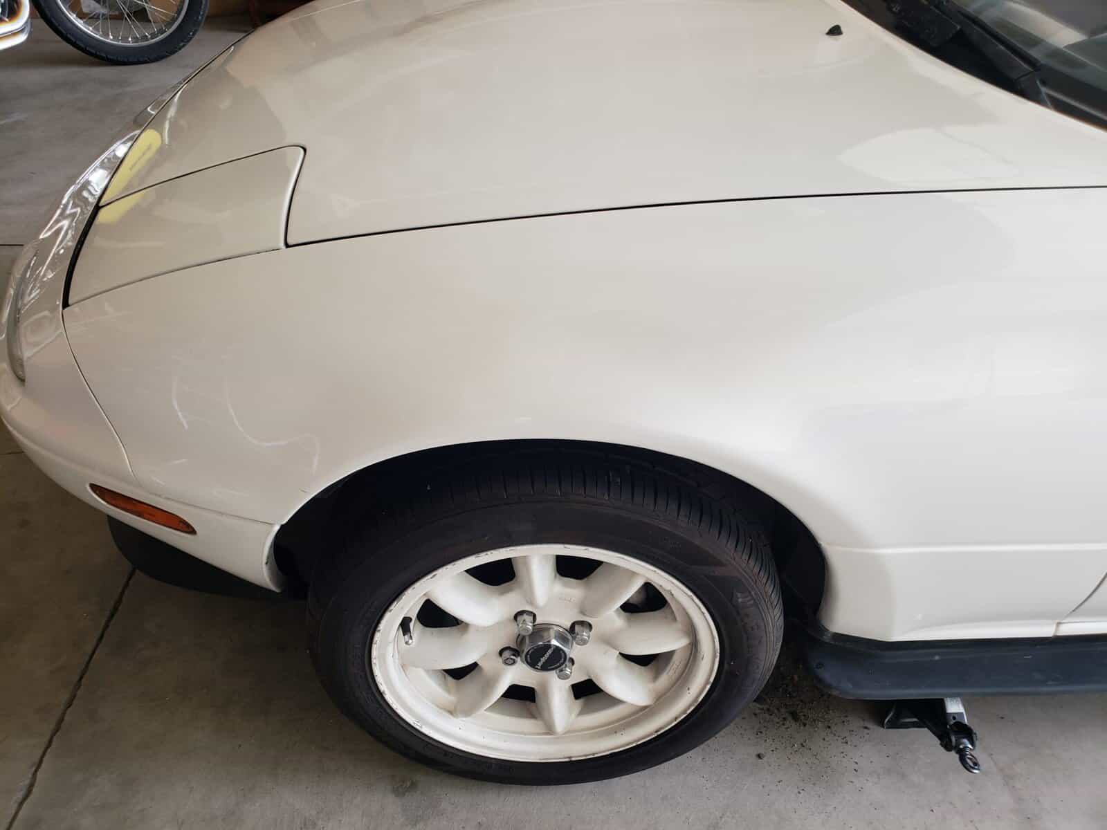 Large fender smash in Mazda Miata repaired with paintless collision repair