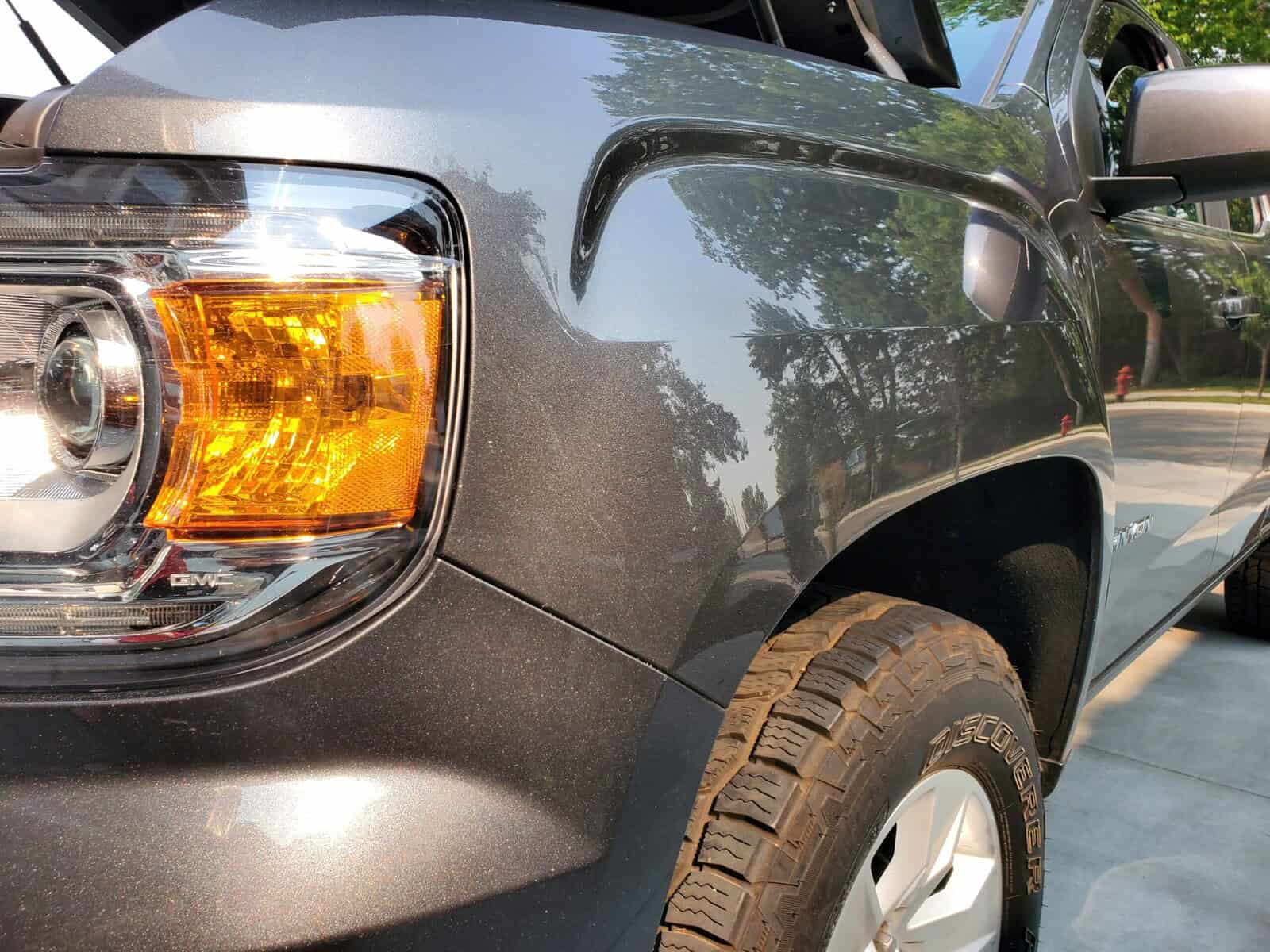 Deep and sharp body line auto body accident on GMC Canyon fender restored with paintless dent repair PDR