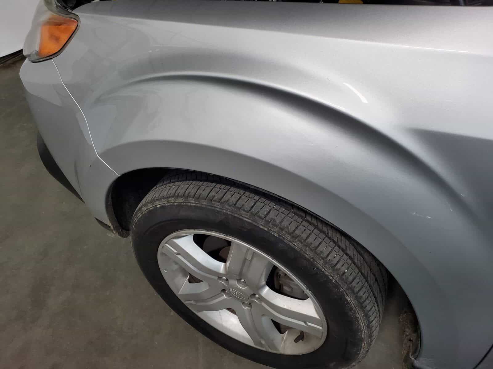 Subaru Forester fender with large deep crease dents restored with paintless dent removal PDR