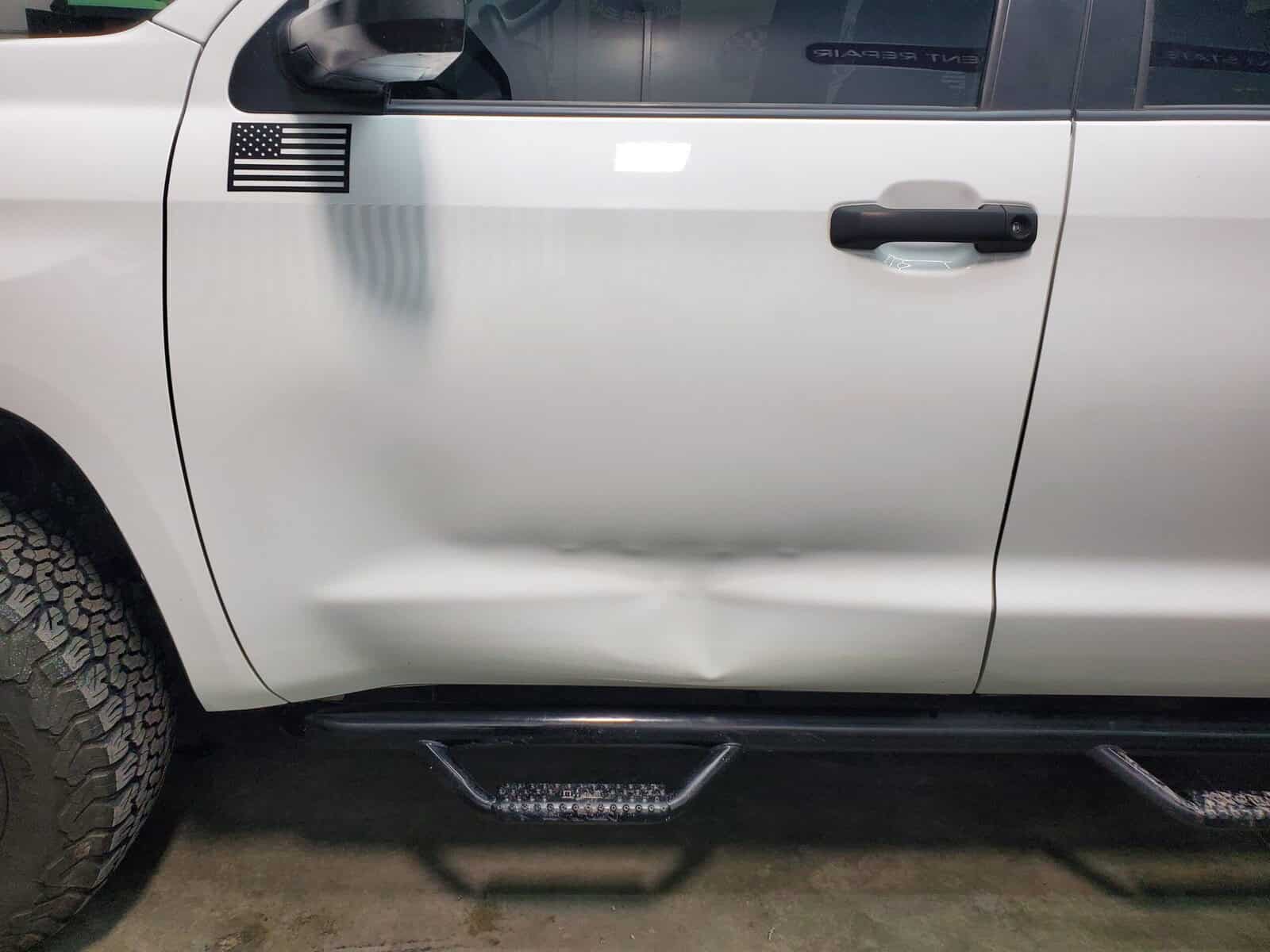 Autobody dent in body line of Toyota Tacoma restored using paintless dent removal and autobody repair techniques