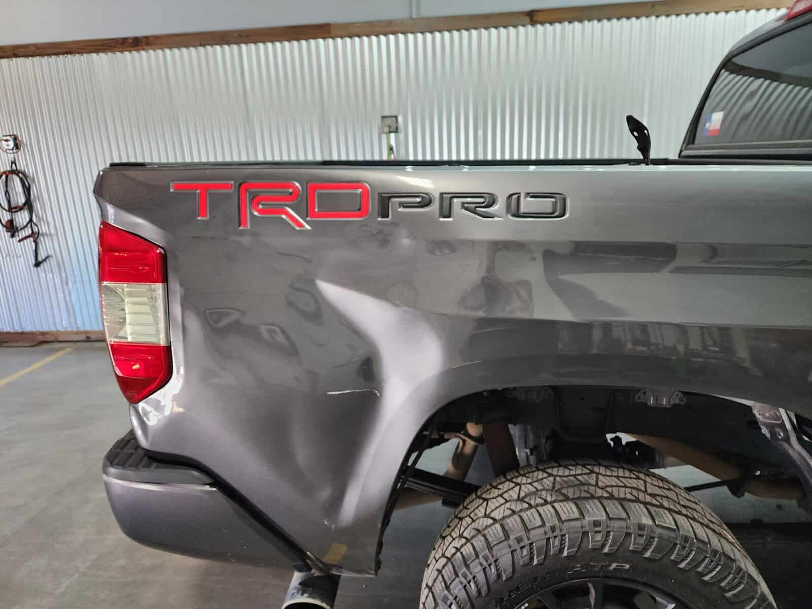 Autobody collision dent in bedside of Toyota Tundra