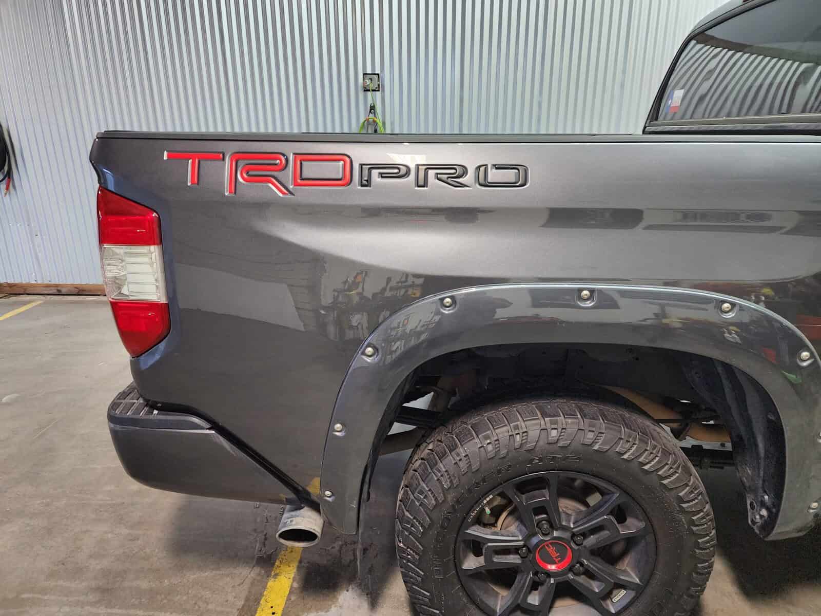 Autobody collision dent in bedside of Toyota Tundra repaired with paintless collision repair