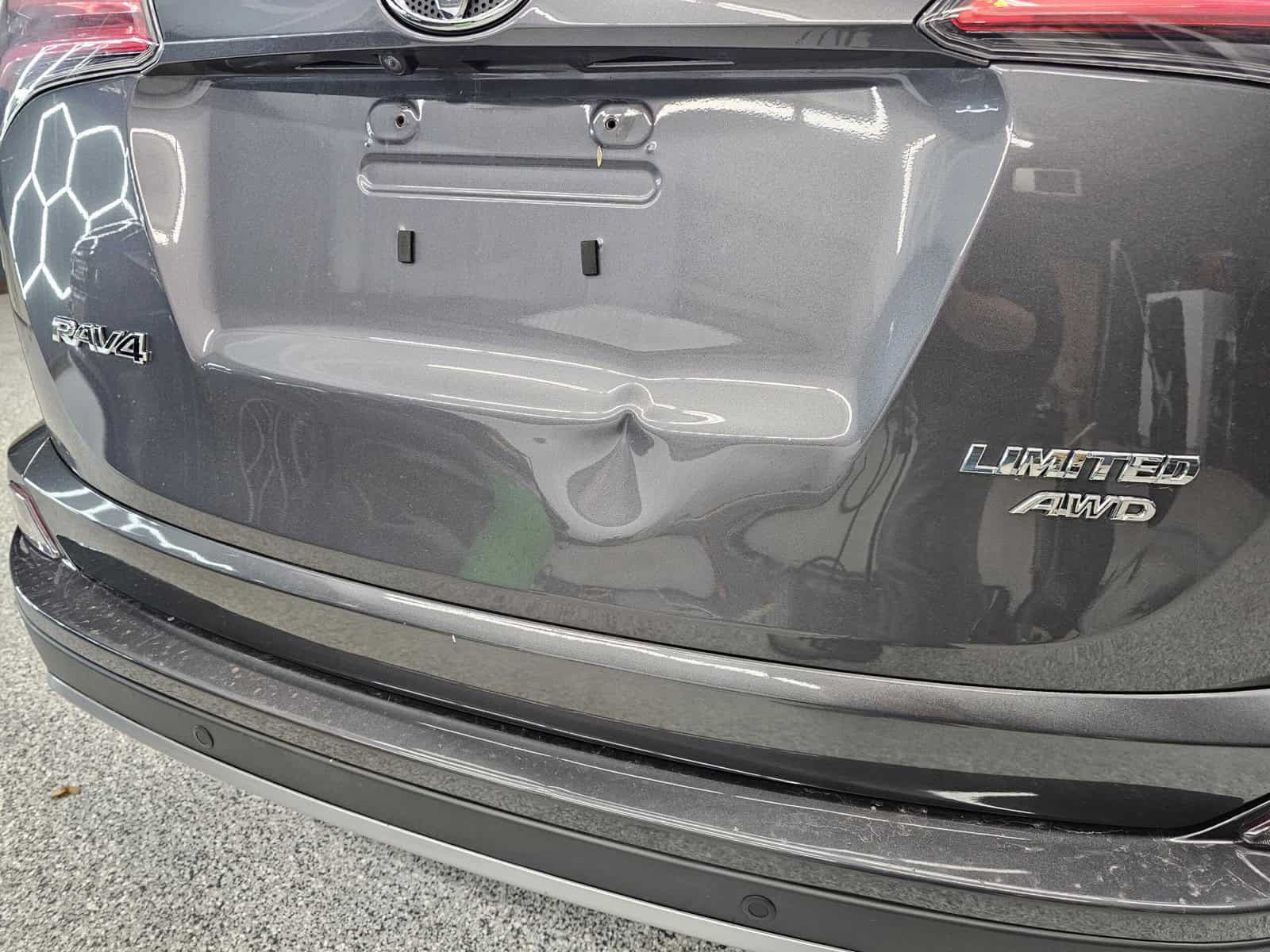 Sharp body line dent due to rear end in hatch of Toyota Rav4