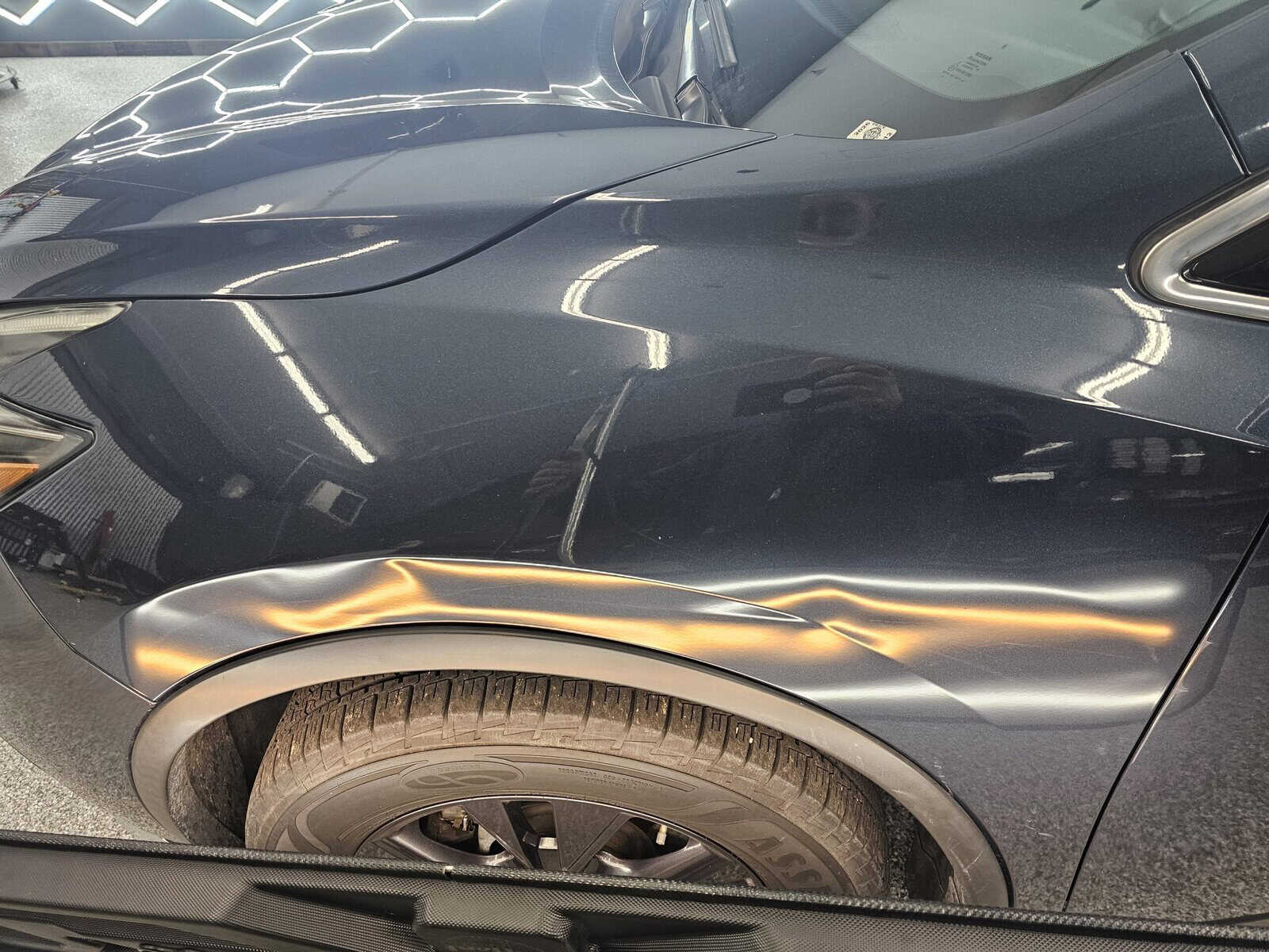 Autobody Collision damage in front fender of Nissan Murano